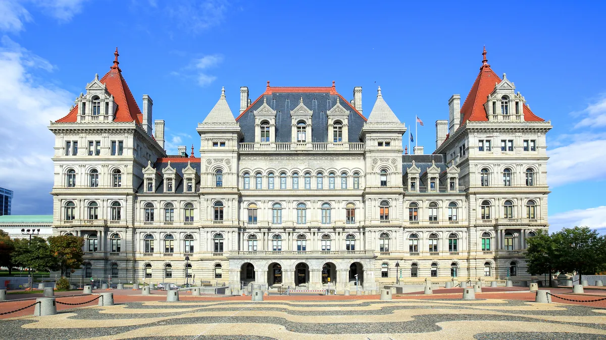 The New York state capitol building, a white building with multiple towers.