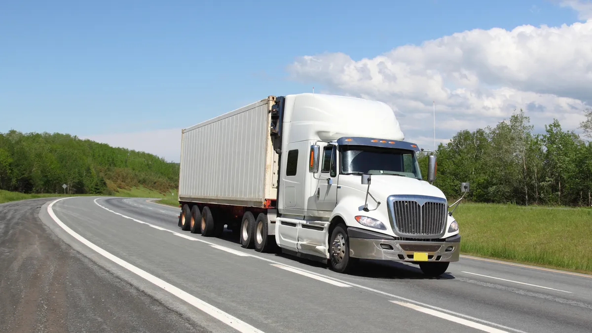 A truck drives on the roadway.