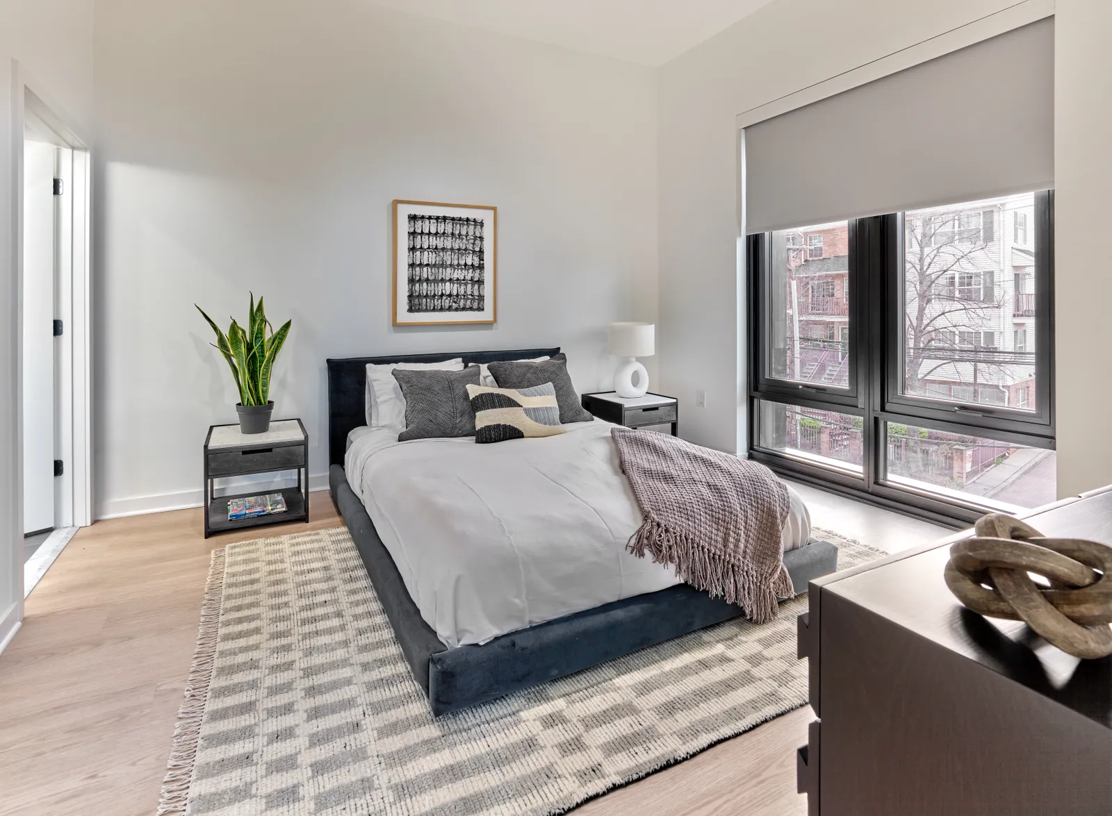 A bedroom with a white bed.