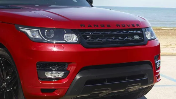 The front grill of a red 2016 Range Rover Sport SUV.