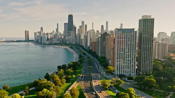 Aerial shot of skyscrapers in Chicago on a clear day in fall with the shore's water snaking along the city's edge.