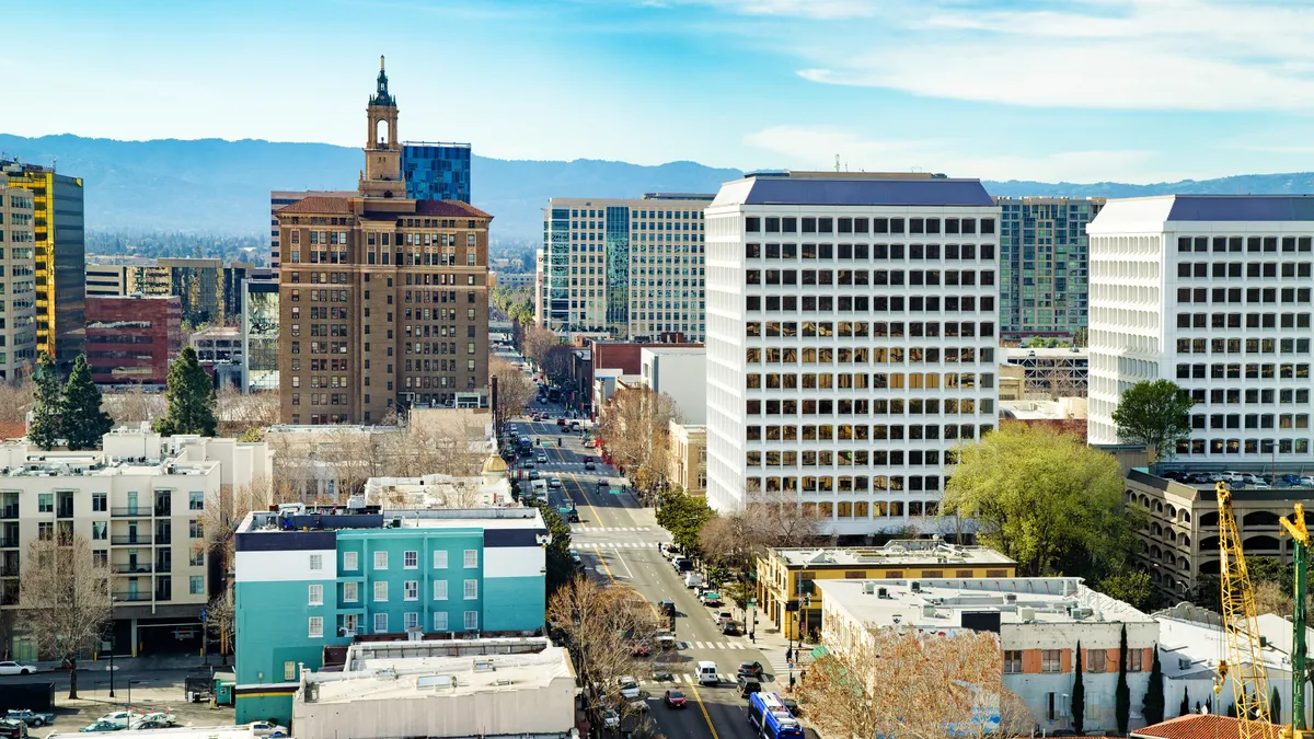 City buildings and downtown street, mountains in background