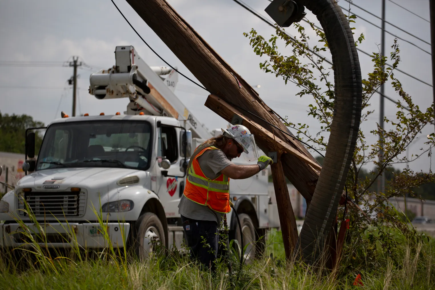 Mutual assistance crews working with CenterPoint Energy work to restore power around Houston, Texas, following Hurricane Beryl.