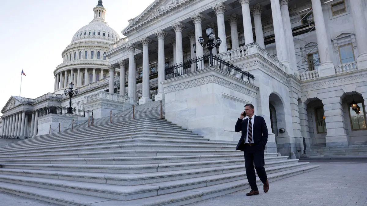 Senator Martin Heinrich takes a phone call in front of the US Capitol building