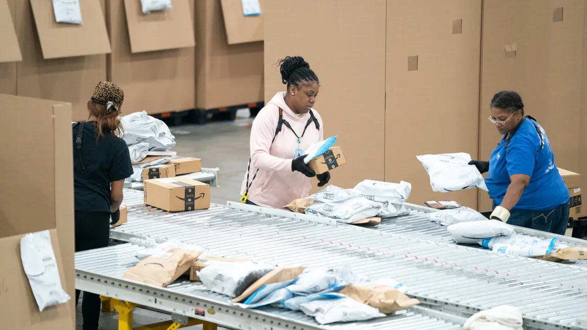 Workers sort packages at the Amazon AGS5 facility on October 27, 2022 in Appling, Georgia.