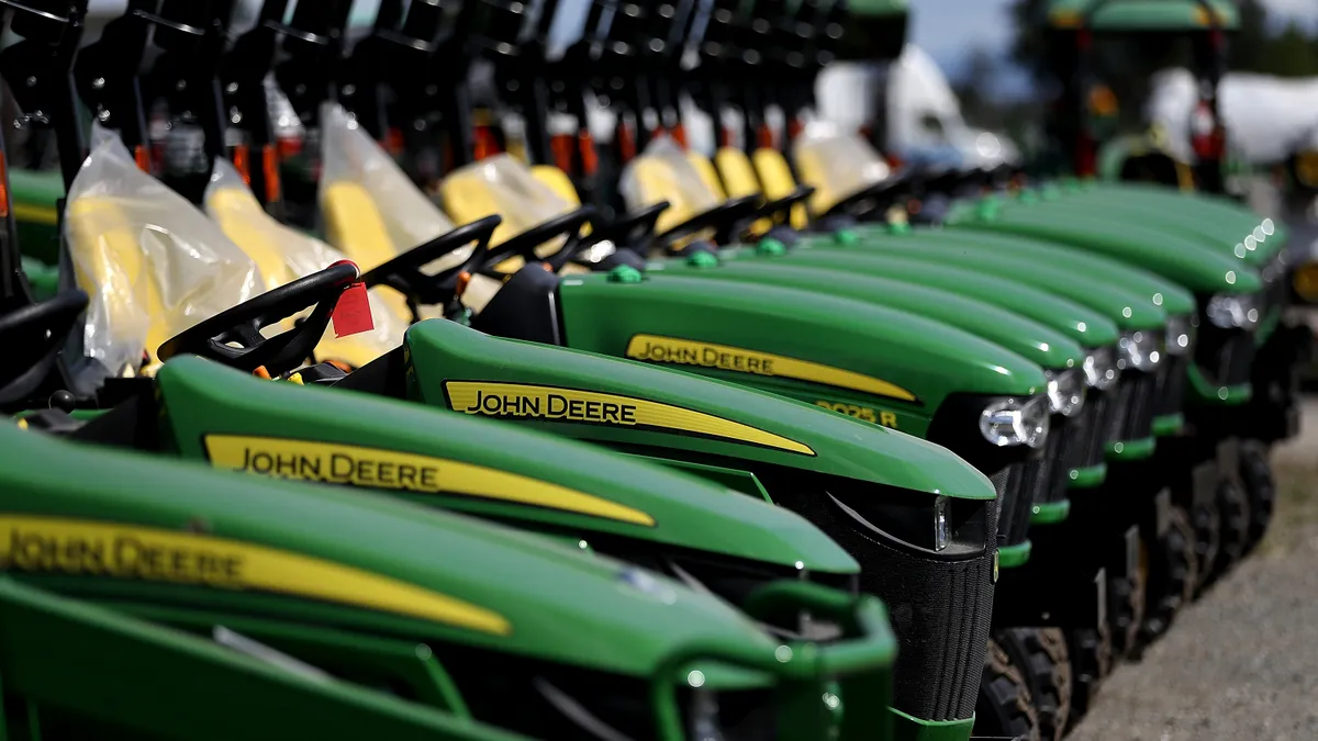 Rows of John Deere tractors with logo displayed