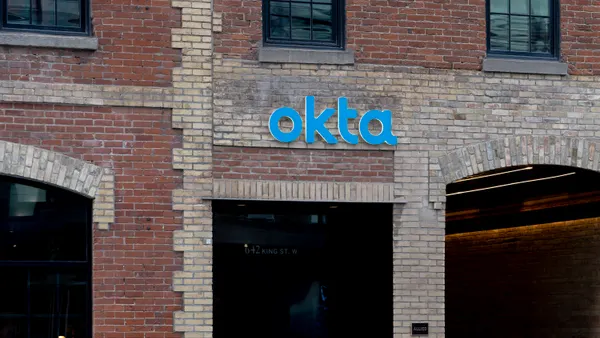 A brick office building with the Okta corporate log on it.