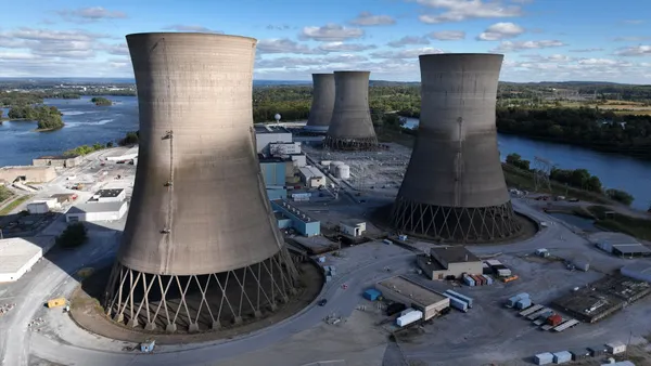 Concrete cooling towers are part of a nuclear power plant.