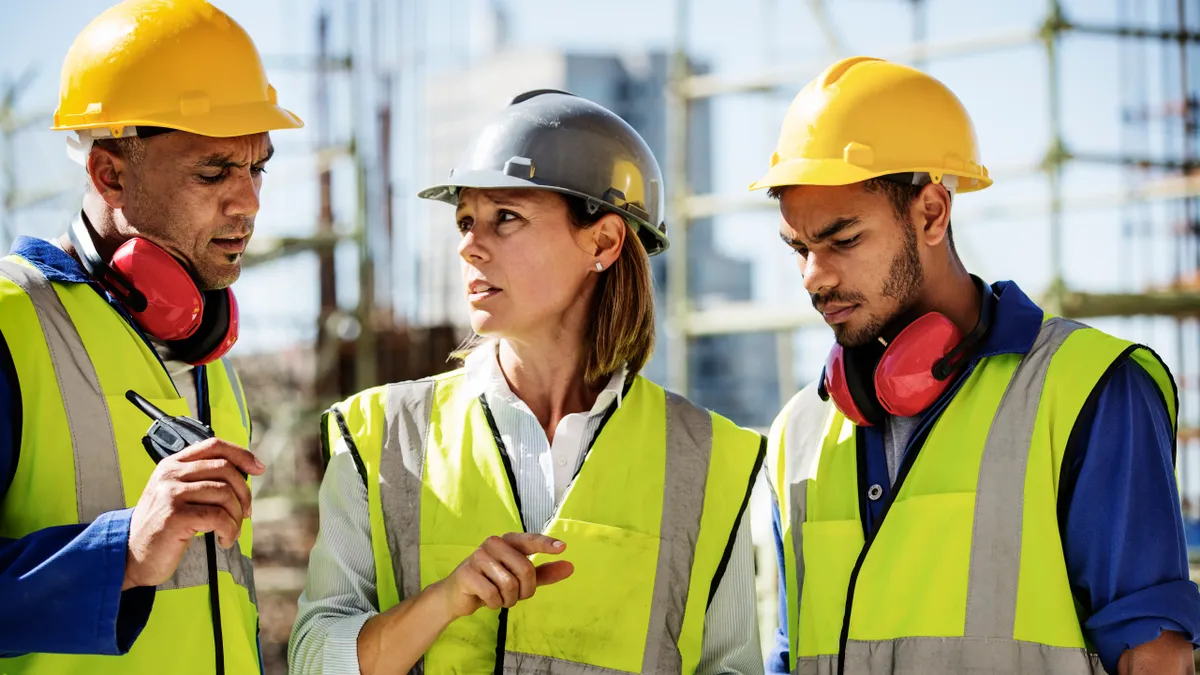 Architects using digital tablet at site