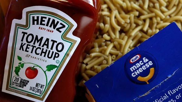 A bottle of Heinz tomato ketchup is displayed next to a box of Kraft Mac & Cheese