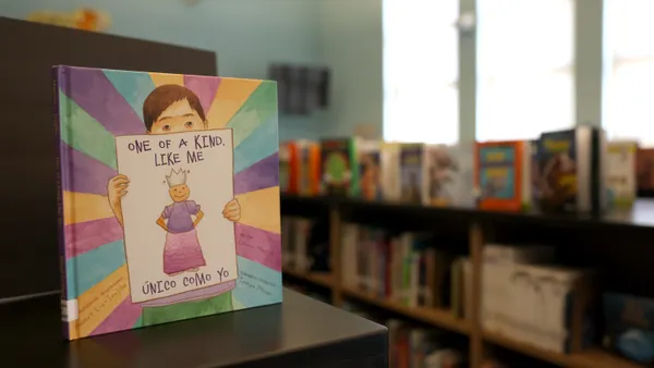 A book titled "One Of A Kind, Like Me" sits on a bookshelf in California
