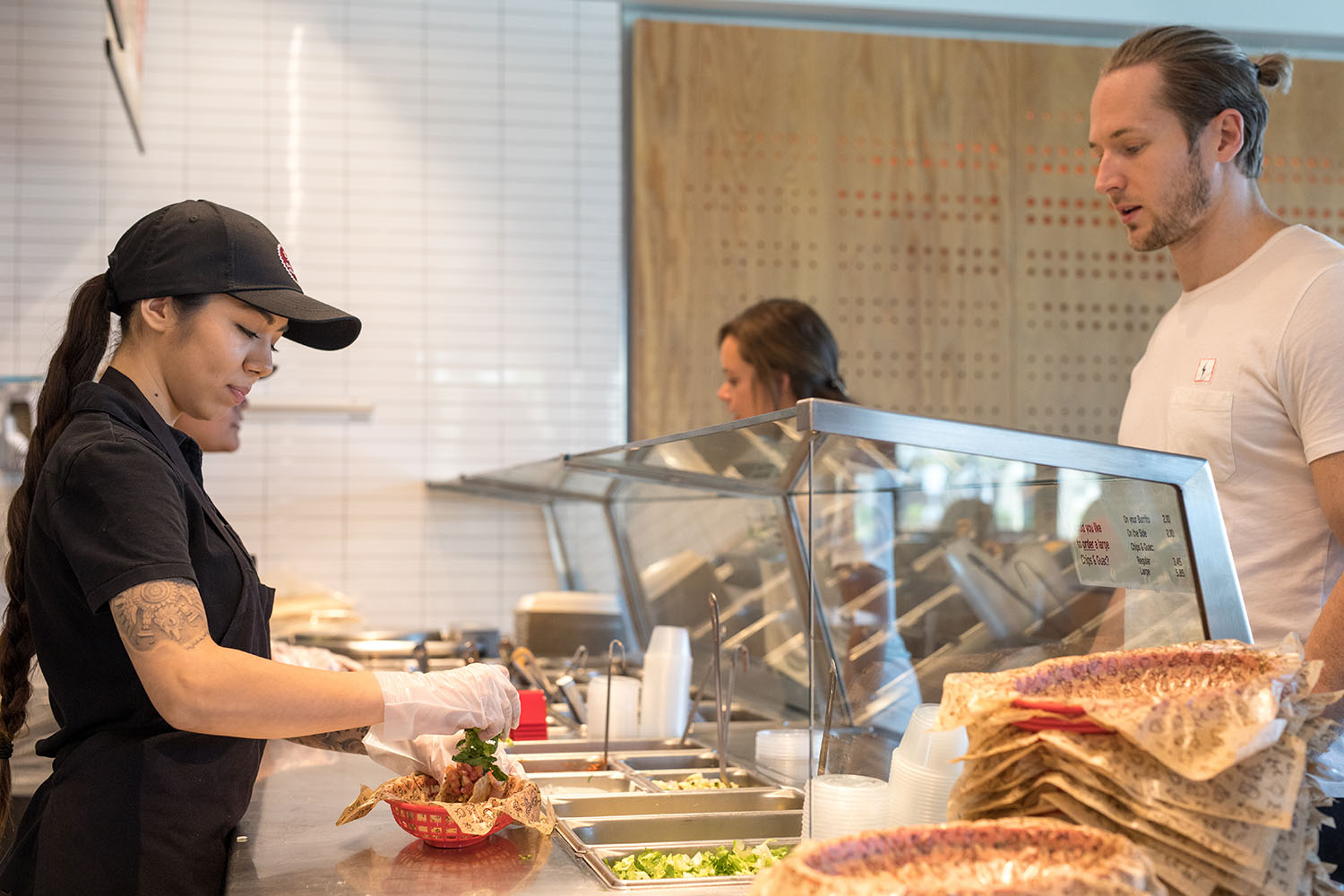 Chipotle employee preparing a meal.