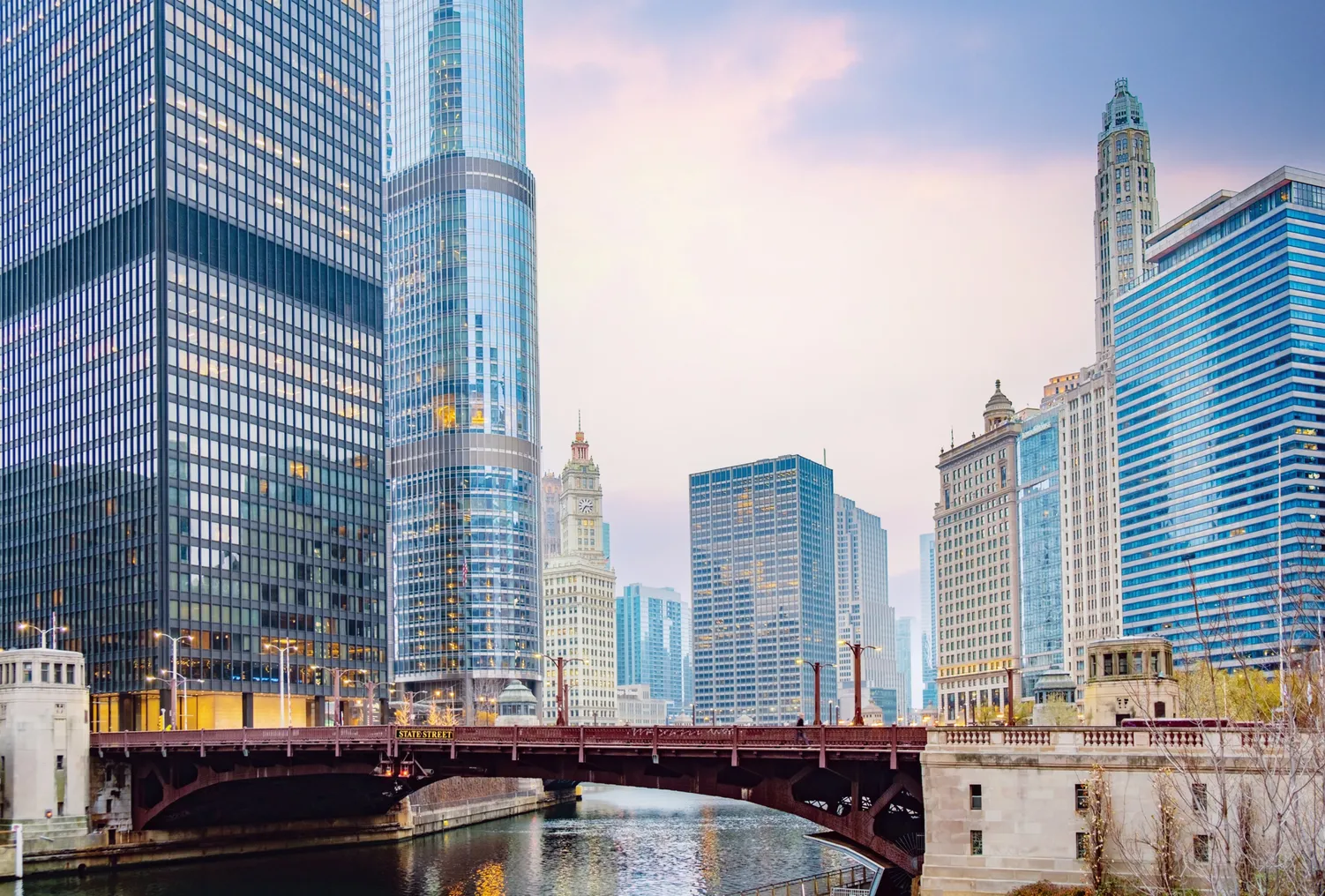 A cityscape of skyscrapers and commercial buildings around State Street Bridge in Chicago.