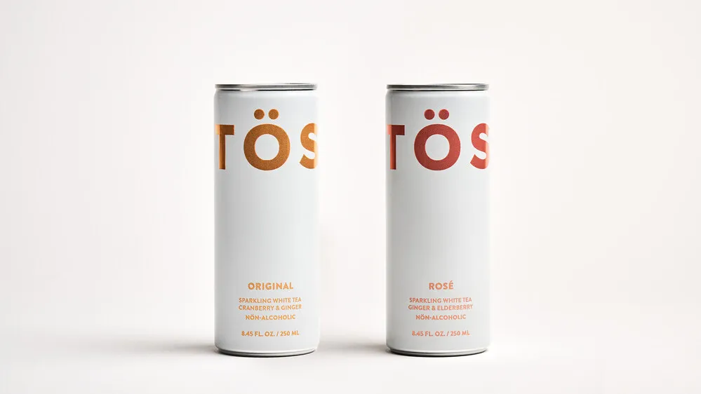 Two cans of sparkling drinks with Töst Beverages branding.