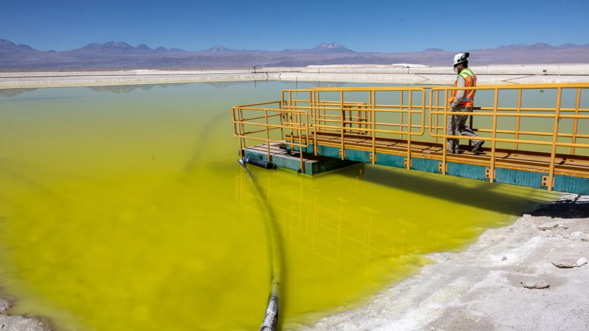 Man standing on a platform at a lihium mining operation in Chile