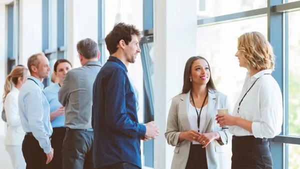 A group of business executives networking at a conference.