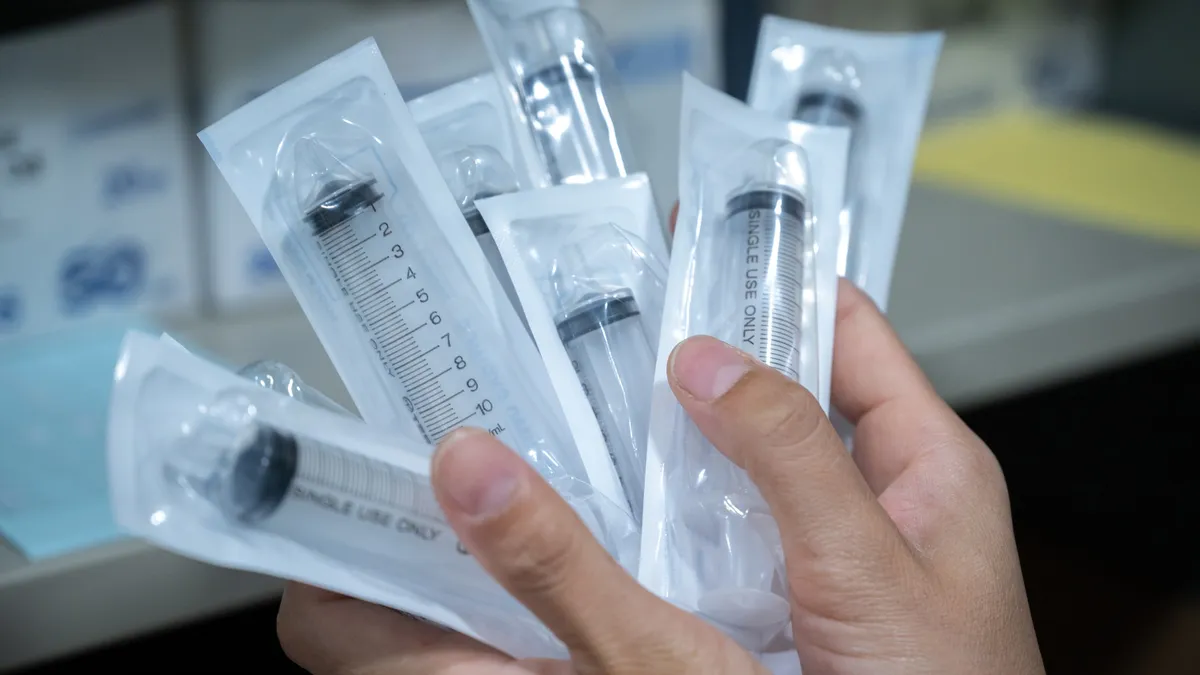 A collection of plastic syringes in packaging.