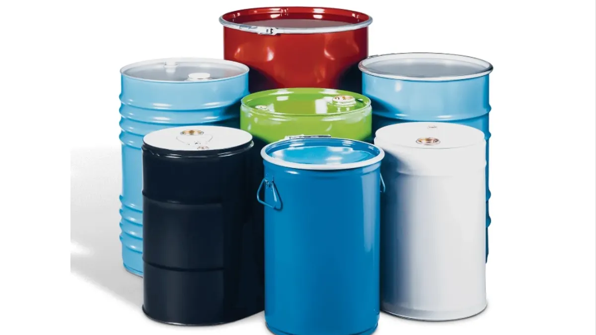 A variety of different colored industrial steel drums.