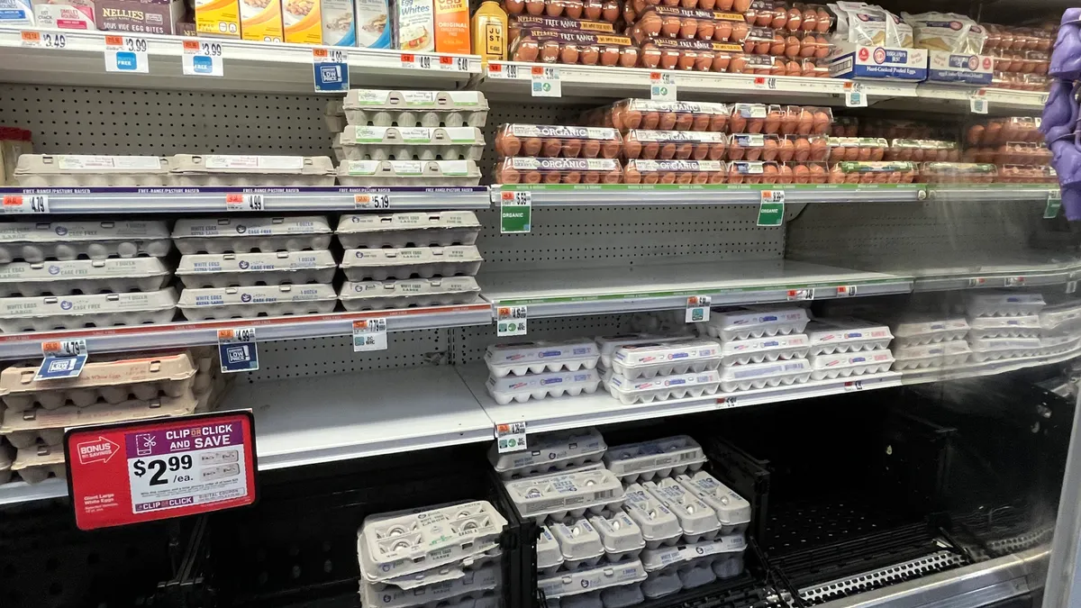 Eggs on shelves at a grocery store.