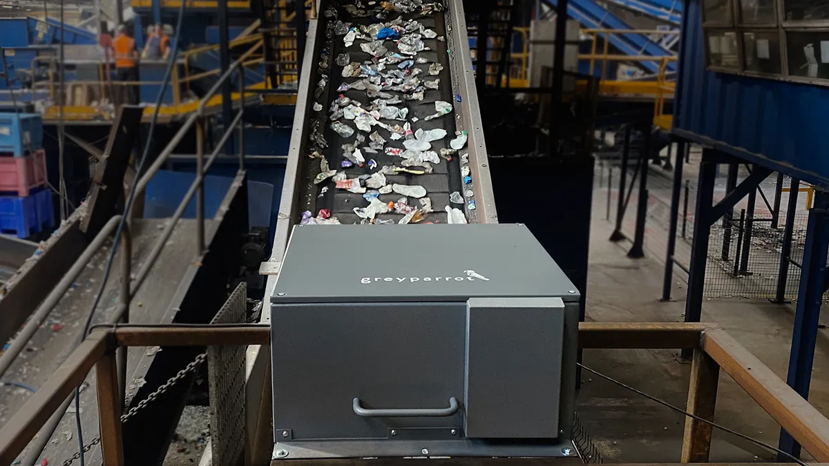 A Greyparrot AI system sits on top of a sorting line