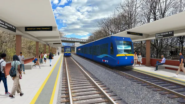 A sleek blue train pulls into a station.