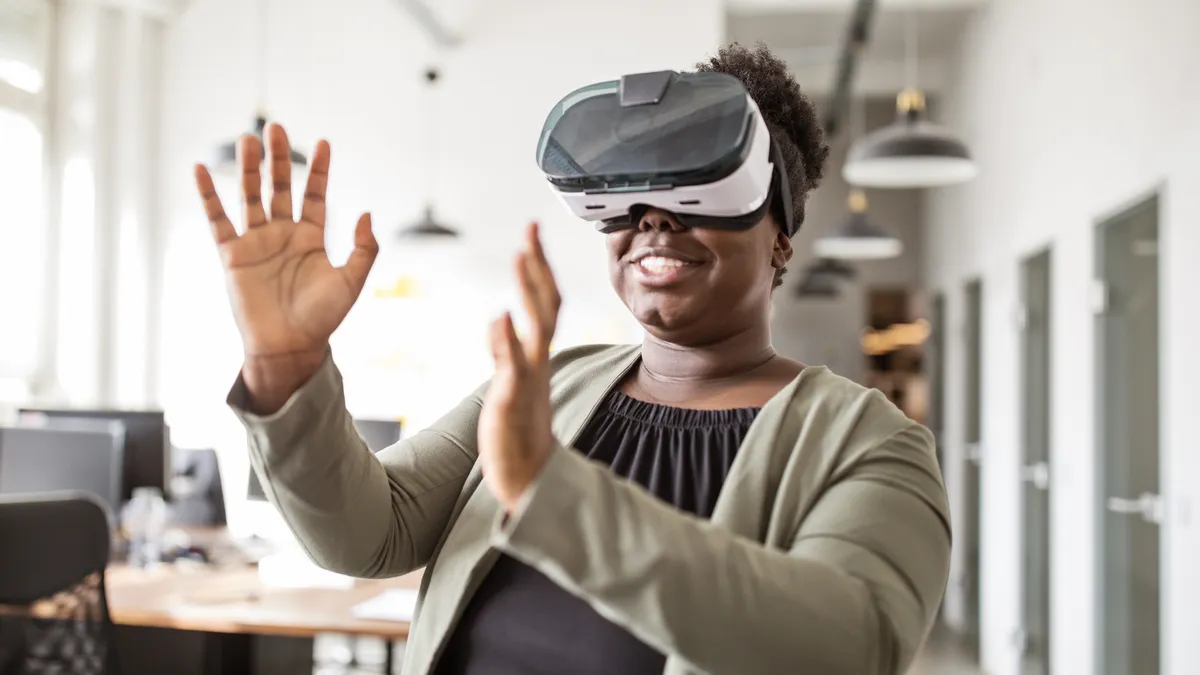 An office worker uses a virtual reality headset.