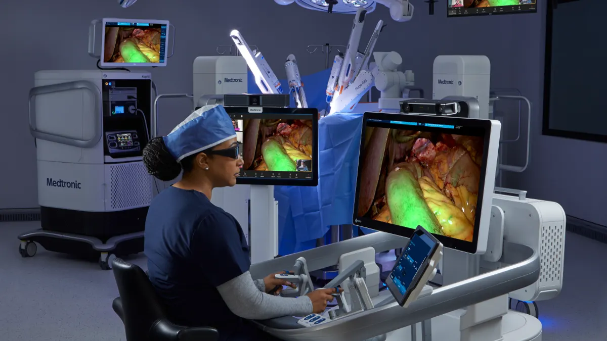 A physician sits at the console of Medtronic's Hugo robotic surgery system.