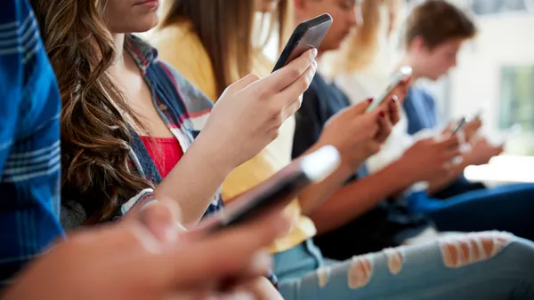 Students on their phones using social media