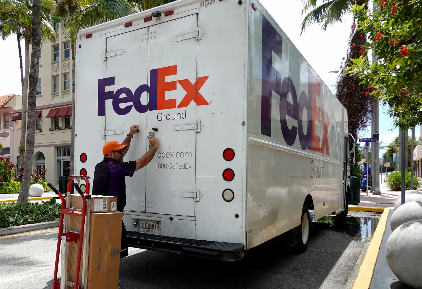 A FedEx worker makes a delivery on September 16, 2022 in Miami Beach, Florida.