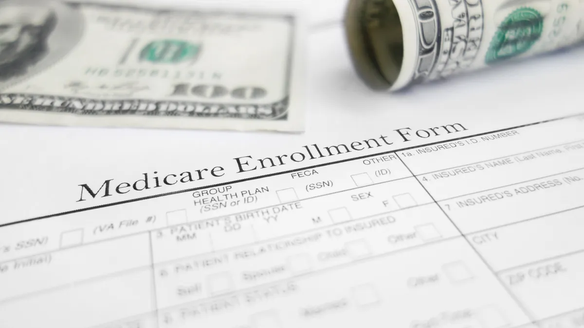 Medicare enrollment form and money.