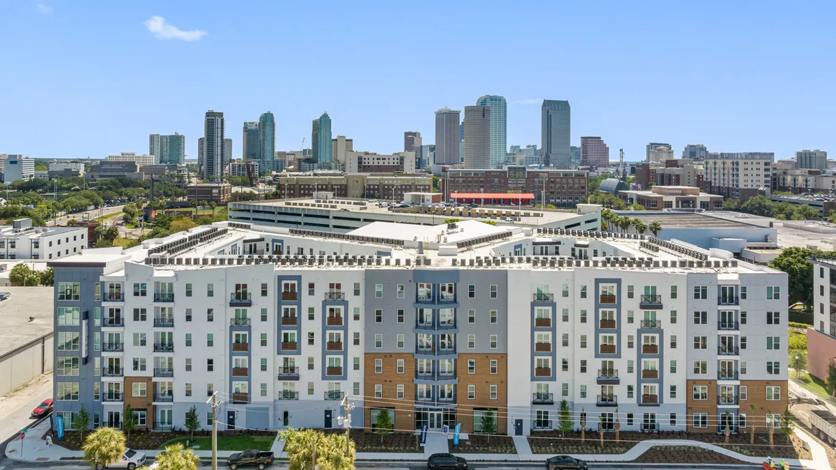 A blue and white mid-rise apartment building.