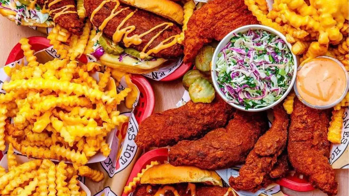 Dave's Hot Chicken food spread out on a table.