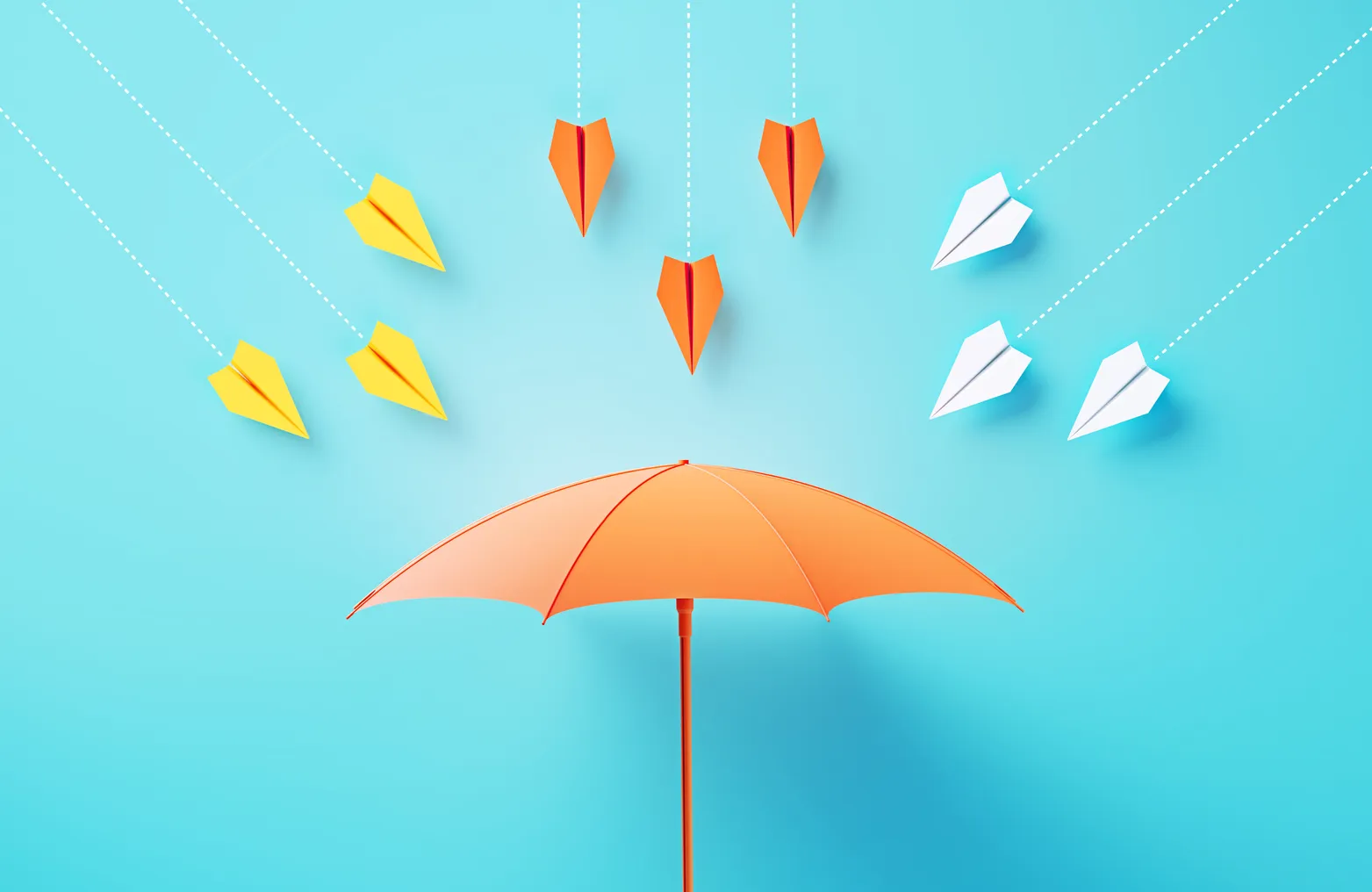 Yellow, orange and white paper airplanes head toward an orange umbrella