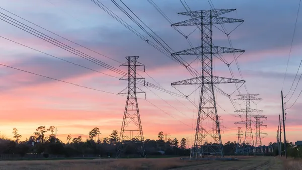 Industrial background group silhouette of transmission towers (or power tower, electricity pylon, steel lattice tower) at suburb area in Texas, USA.