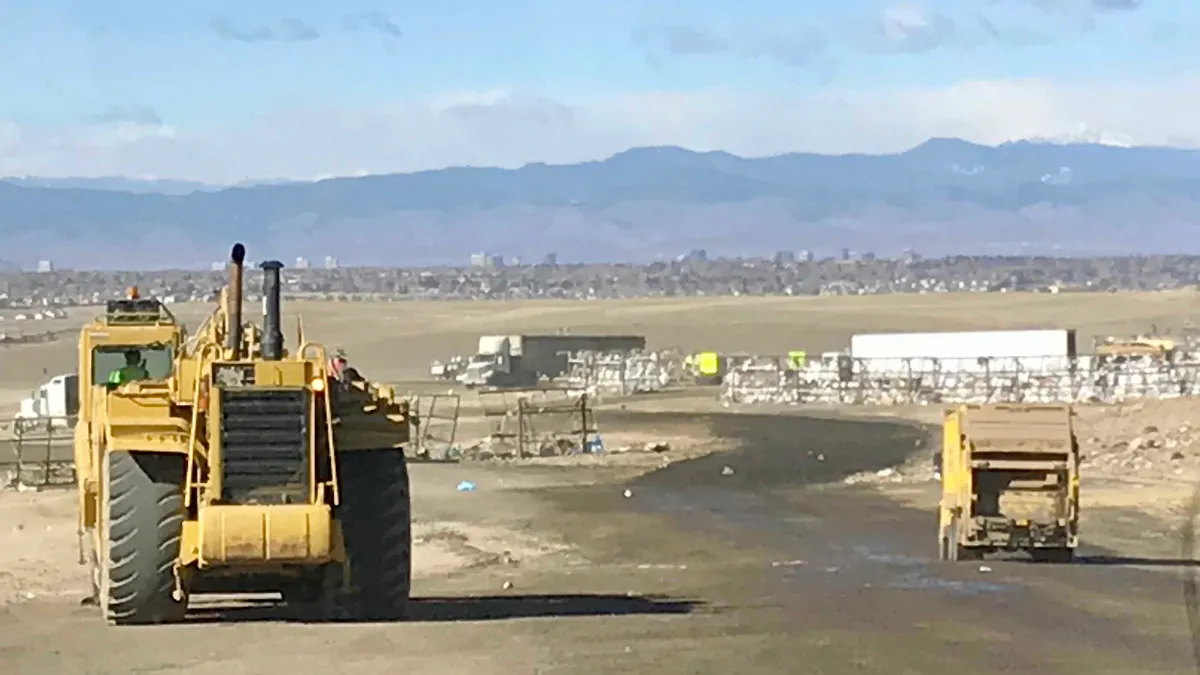Heavy equipment driving at a landfill in the Denver area