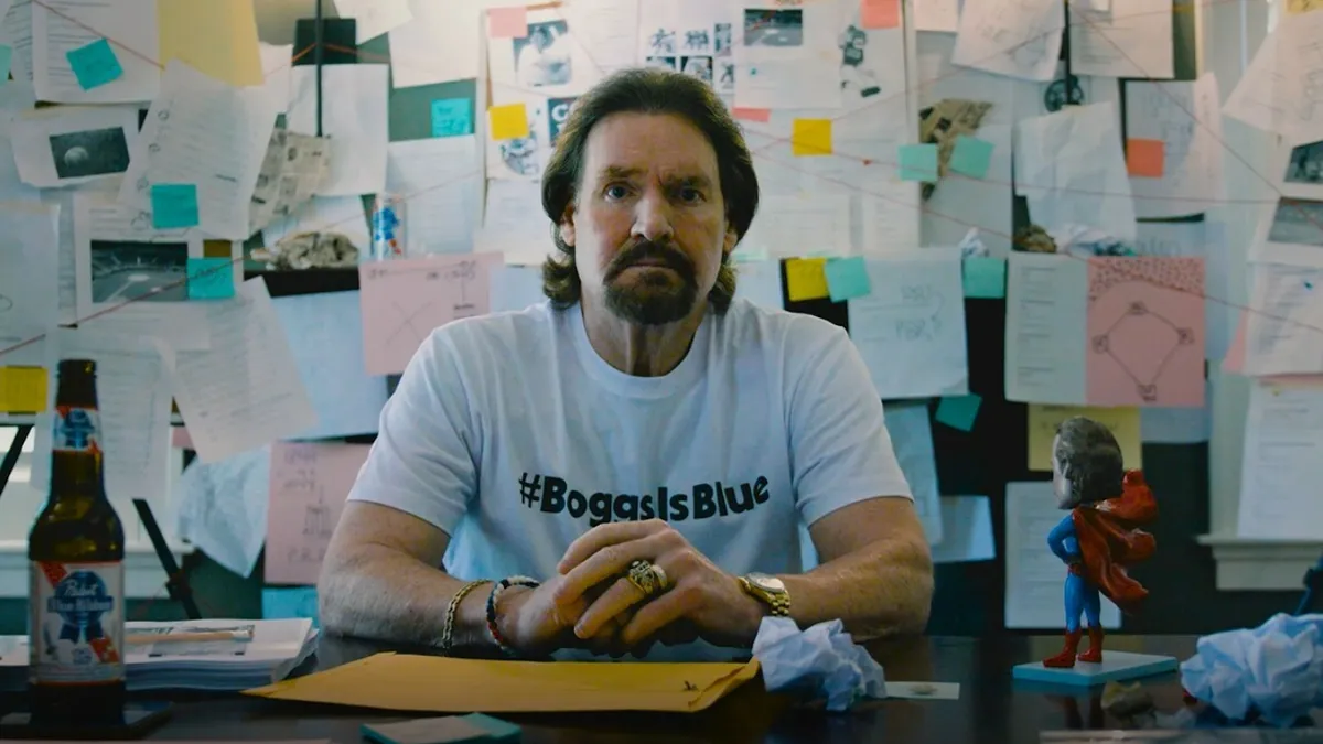 Baseball Hall of Famer Wade Boggs sits at a desk.