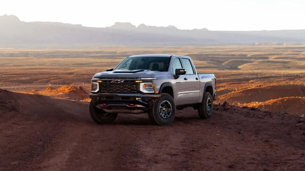 A 2027 Chevrolet Silverado 1500 ZR2 in painted in White Sands parked on a dirt trail.