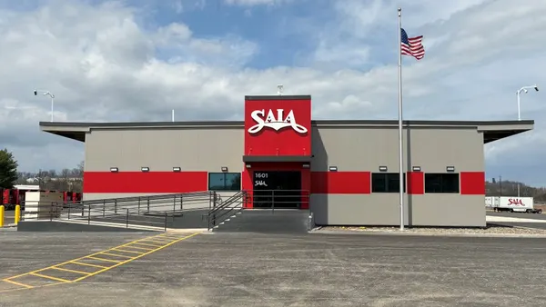 The outside of a new terminal for Saia in York, Pennsylvania, with an American flag on a flagpole.
