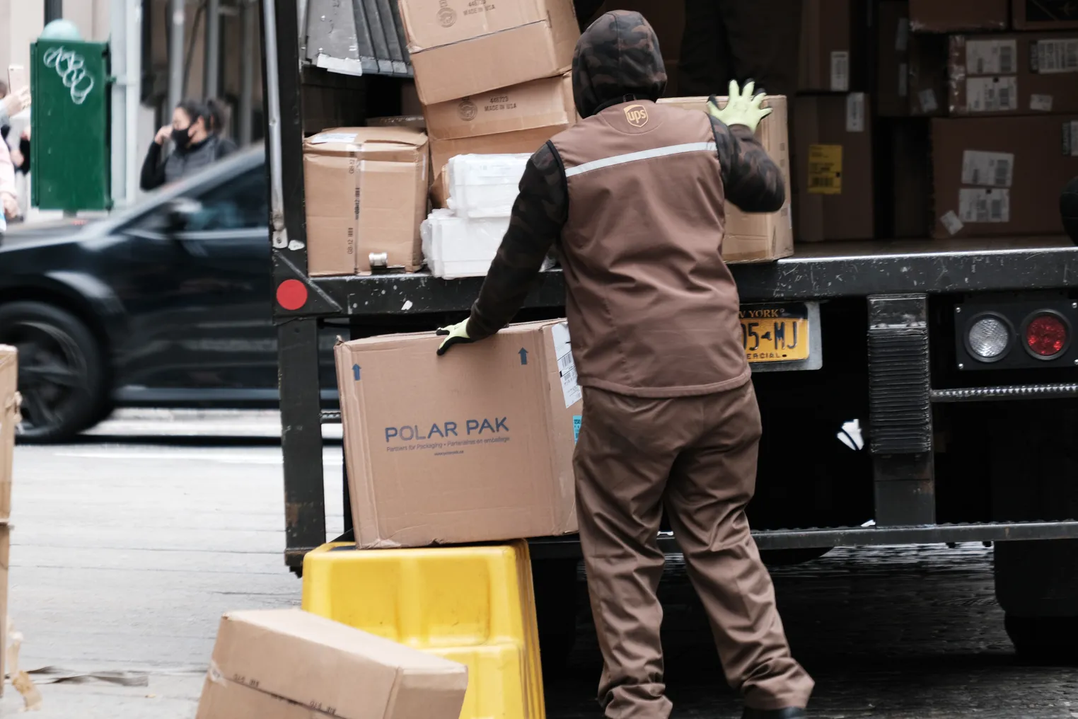 A UPS worker delivers boxes in Manhattan on April 26, 2022 in New York City.