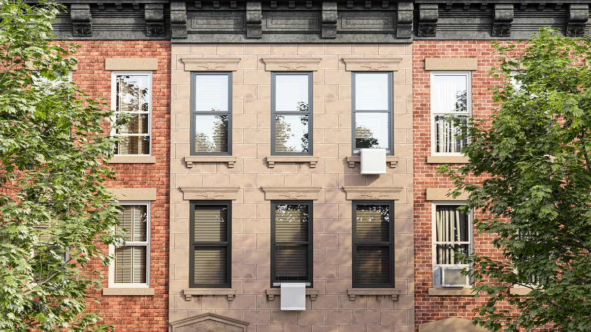 Gradient heat pump units showing on the exterior of a residential building.