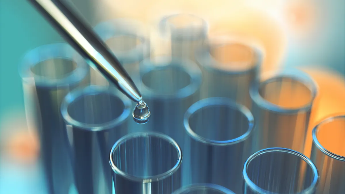 Close up of a droplet being dropped into a test tube