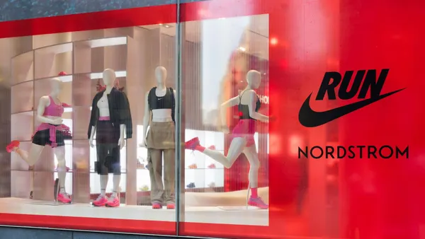 A window features mannequins in running apparel next to Nordstrom and Nike logos.