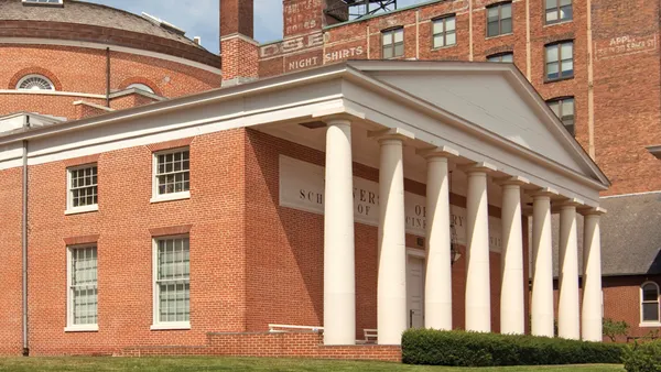 Brick building front with columns.