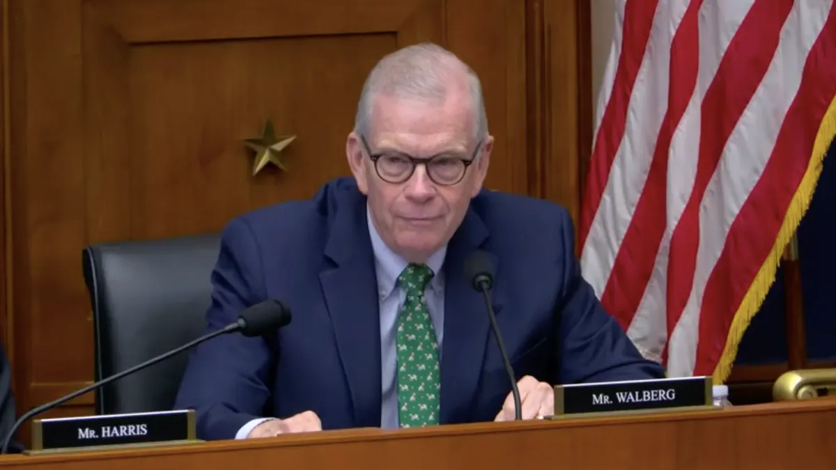 Rep. Walberg speaks nto a microphone