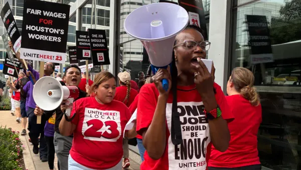 A worker speaks into a megaphone.