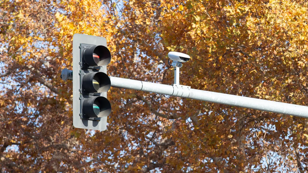 A smart sensor mounted on an overhead traffic signal.