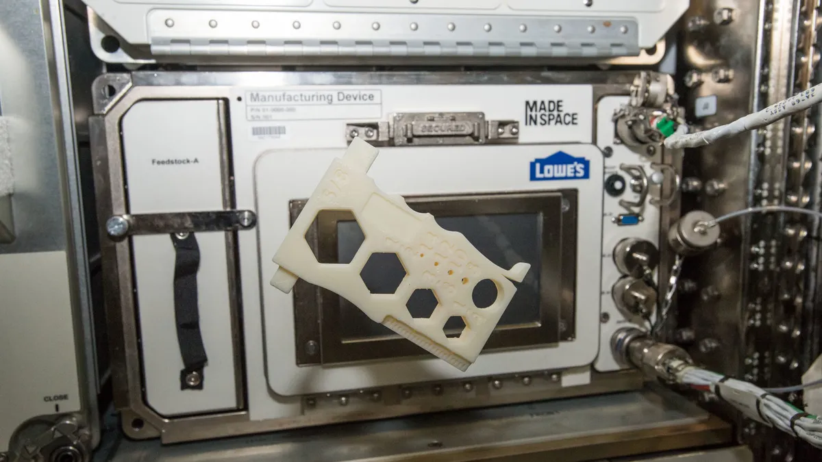 A 3D printed tool floats in front of Redwire's Additive Manufacturing Facility aboard the International Space Station.