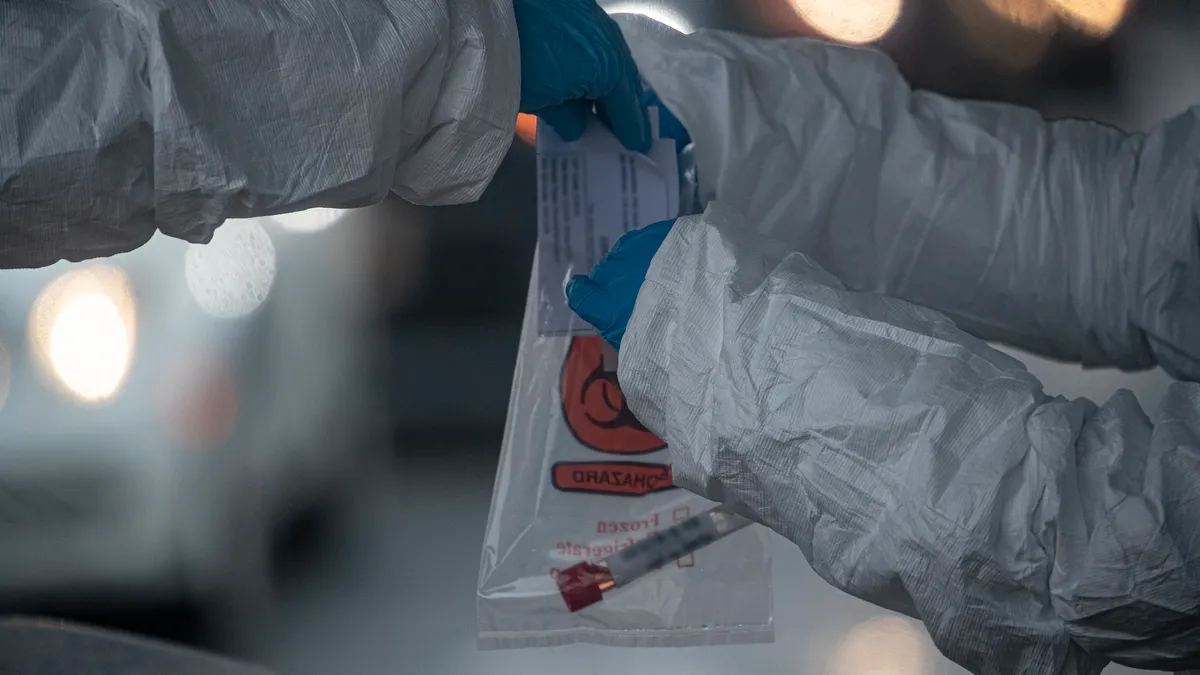 New Jersey Air National Guard medics with the 108th Wing process specimens at a COVID-19 Community-Based Testing Site at the PNC Bank Arts Center in Holmdel, N.J., March 23, 2020. The testing site, es