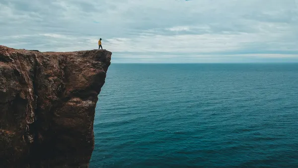 Person standing on high cliff