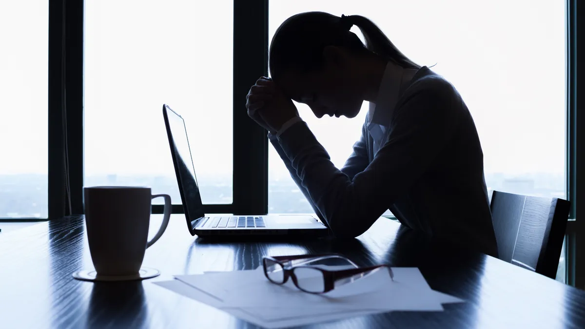 Silhouette of stressed businesswoman in the office.